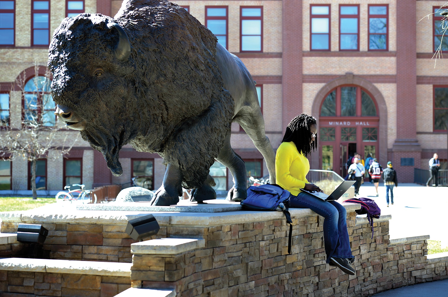 4/13/16 – Student studying outside at the Bison Statue.