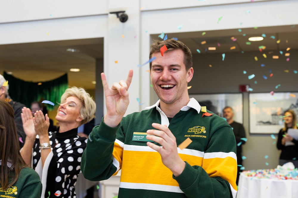Michael Hall, a Bison Ambassador, celebrates after the announcement of the campaign total