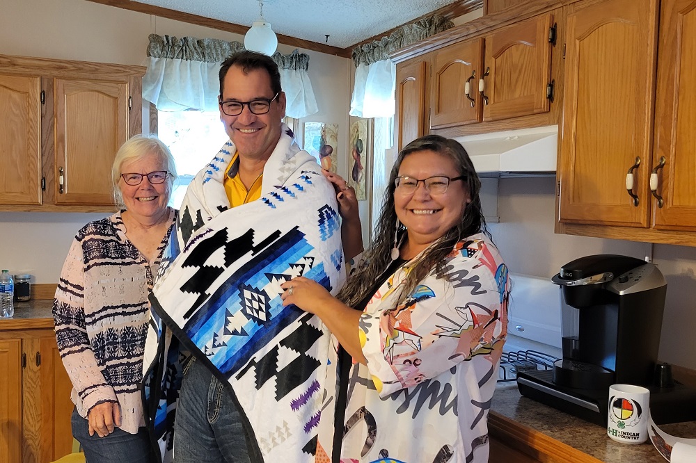 The Sioux County Extension staff gifted a traditional blanket to President Cook.