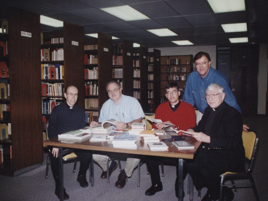 Left to right: Msgr. Robert Laliberte, Stuart Longtin, Msgr. Dennis Skonseng, Michael Miller, and Msgr. Joseph Senger at the Cardinal Muench Seminary Library in Fargo, 2000.