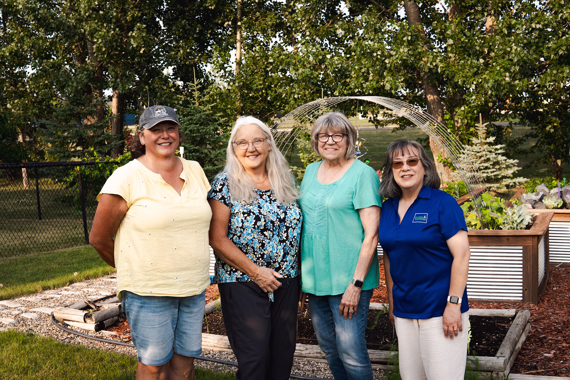 Certified Master Gardener Volunteers Julie Vetter, Deb Miller, and Carol Burley ’82 join Extension horticulturist and program coordinator Dr. Esther McGinnis outside Julie's home garden in Fargo, North Dakota.